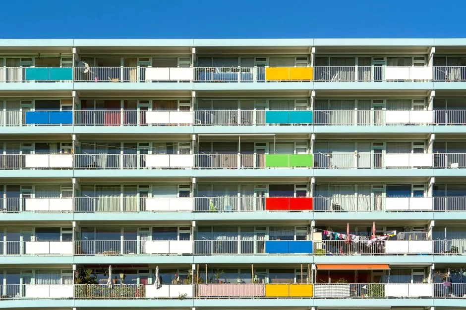 Multi-story apartment building with balconies, an example of the multifamily housing types in HUD's dataset