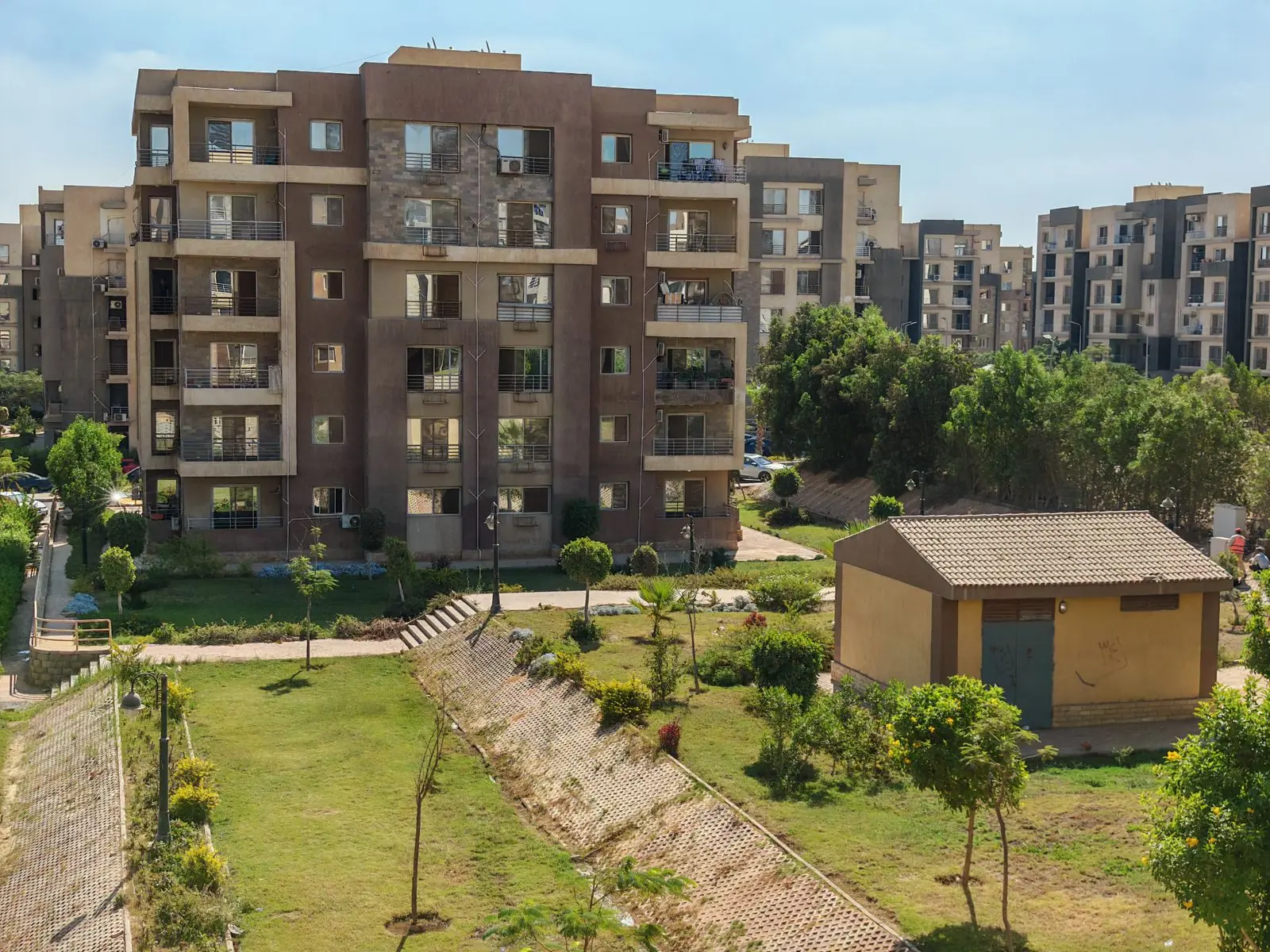 Modern apartment building exterior with landscaped grounds
